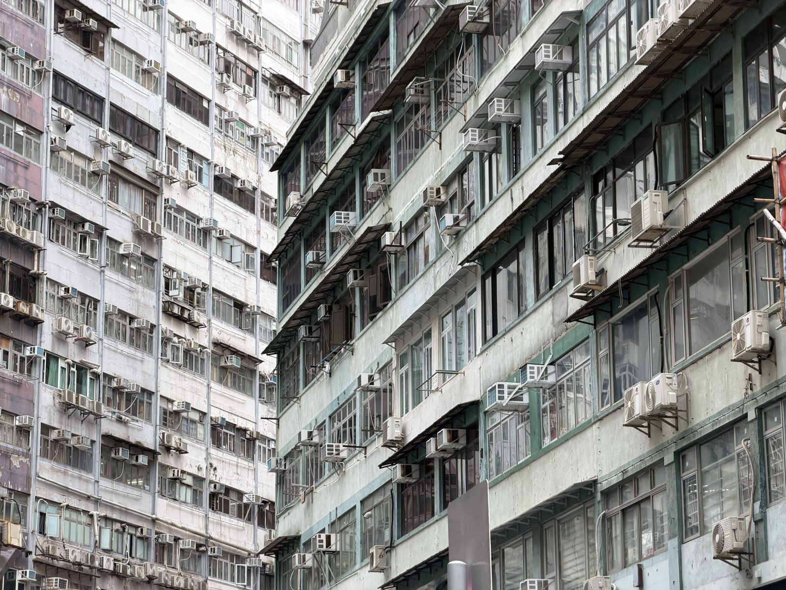 Old tenement buildings covered in air conditioning units